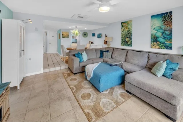 a living room with furniture and painting on the wall