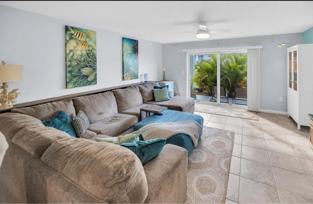 40 High Point Road, Unit C105 Tavernier, FL 33070 - Photo 5 of 8 a living room with furniture and a large window