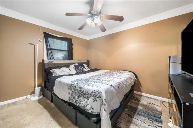 a bed sitting in a bedroom next to a window