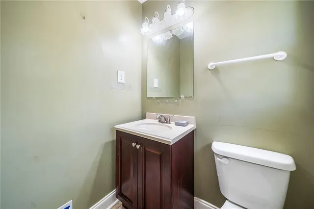 a bathroom with a sink a toilet and a mirror