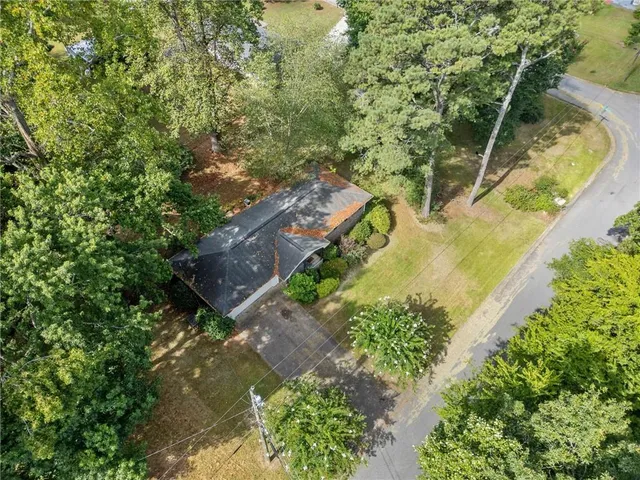 an aerial view of a house with a yard