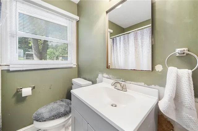 a bathroom with a shower curtain and a window