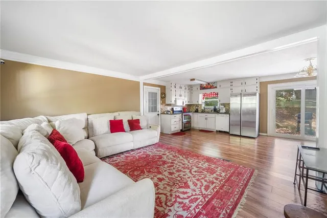 a living room with furniture and kitchen view