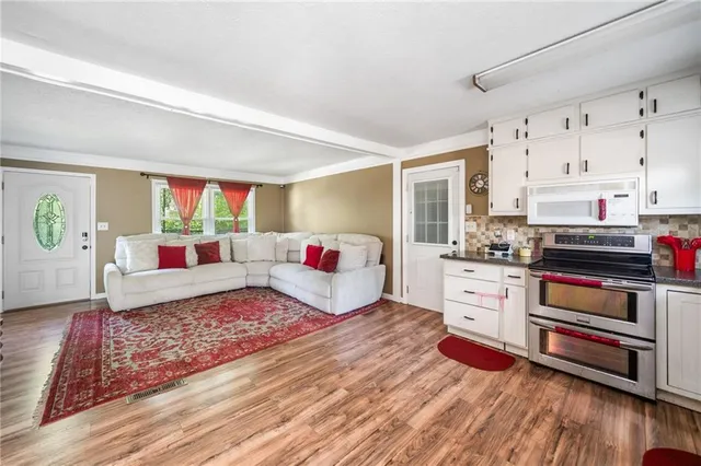 a bedroom with furniture and a wooden floor
