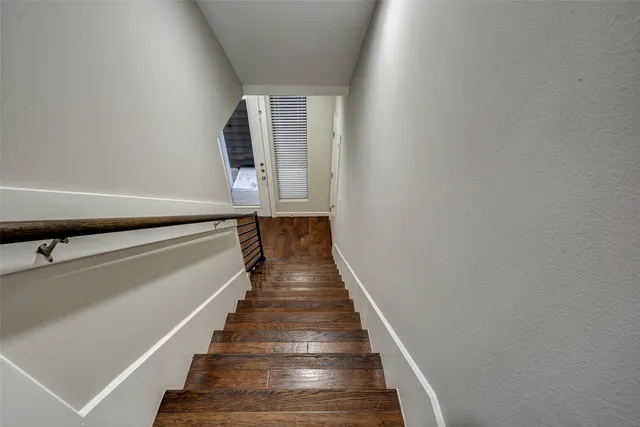 a view of an entryway with wooden floor and staircase