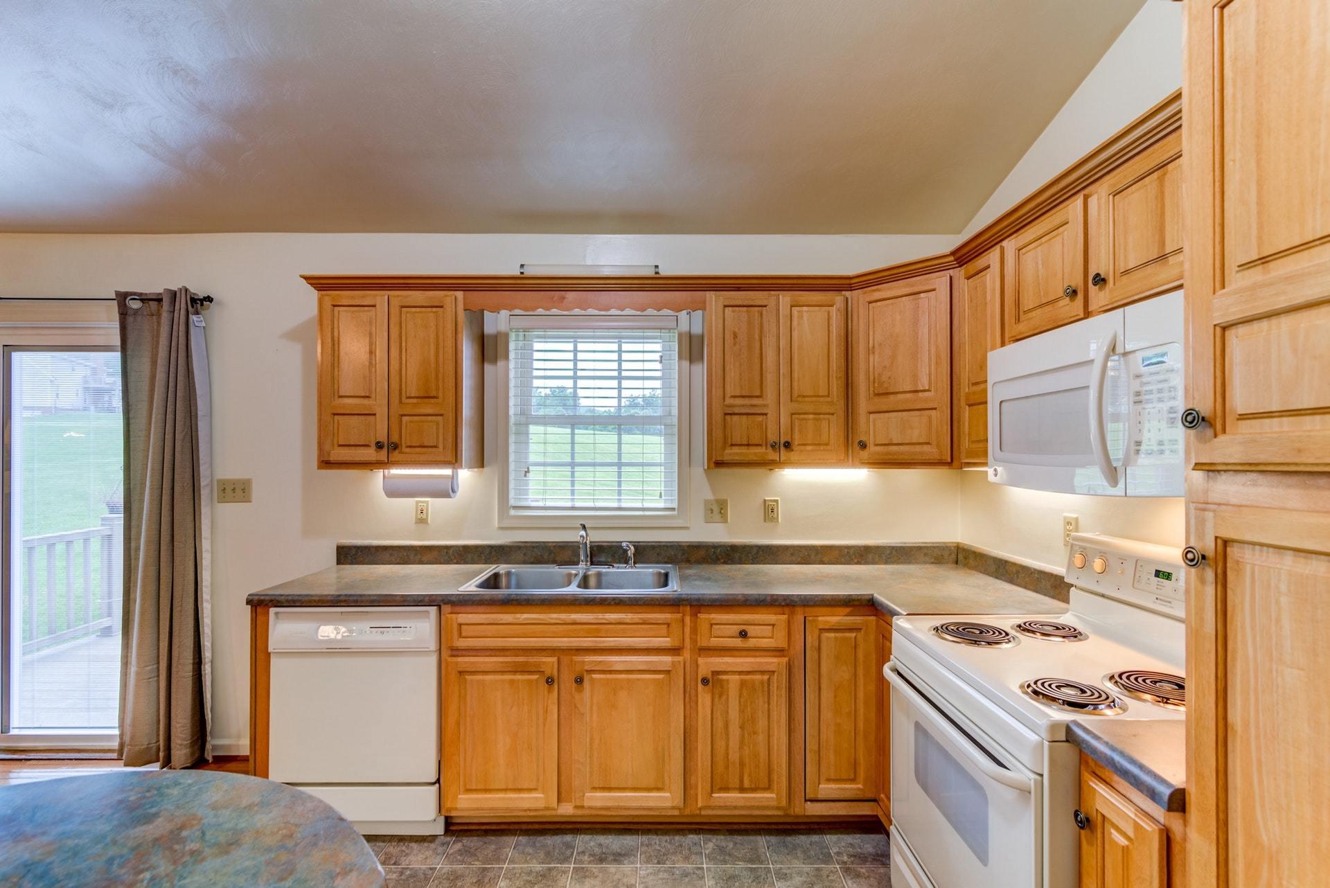 1632 Meadows Road Vinton, VA 24179 - Photo 12 of 47 a kitchen with granite countertop a sink stove and cabinets