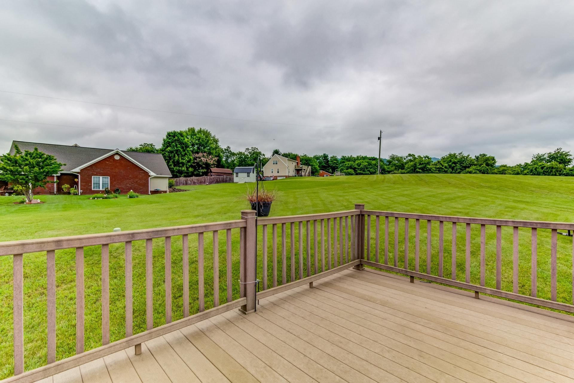 1632 Meadows Road Vinton, VA 24179 - Photo 15 of 47 a view of a deck with wooden floor and fence with a big yard
