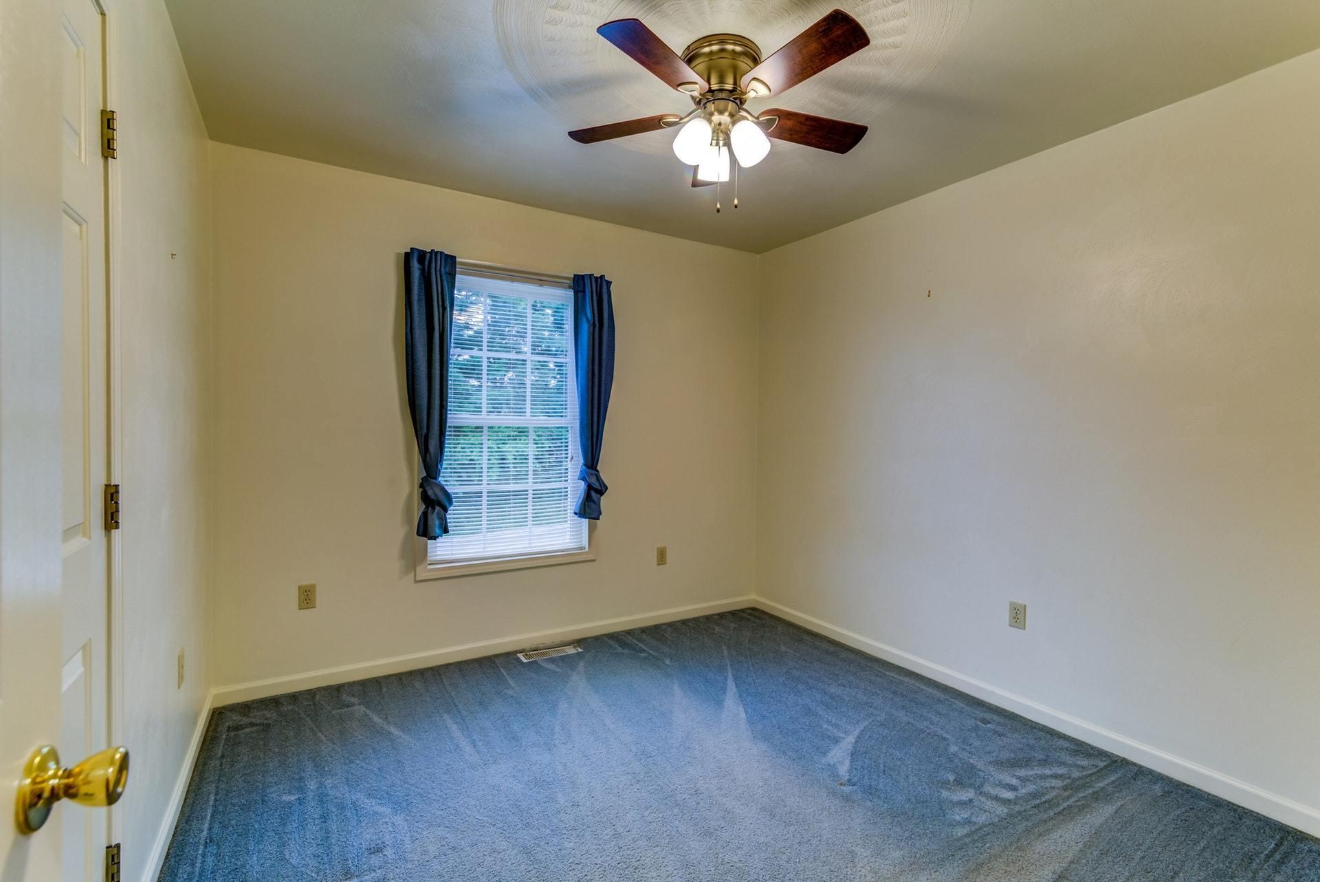 1632 Meadows Road Vinton, VA 24179 - Photo 18 of 47 an empty room with a window and a ceiling fan