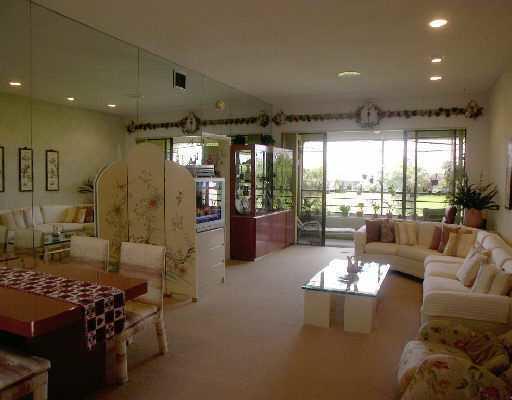 7508 La Paz Court, Unit 304 Boca Raton, FL 33433 - Photo 2 of 5 a living room with furniture and a large window