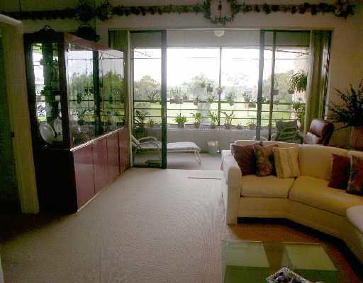 7508 La Paz Court, Unit 304 Boca Raton, FL 33433 - Photo 3 of 5 a living room with furniture and a large window