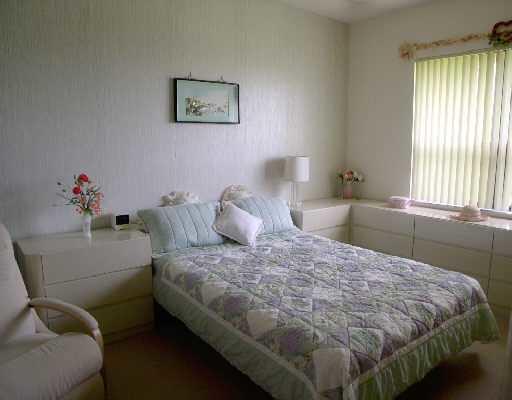 7508 La Paz Court, Unit 304 Boca Raton, FL 33433 - Photo 4 of 5 a bedroom with a bed and window