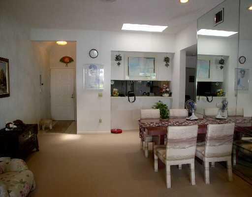 7508 La Paz Court, Unit 304 Boca Raton, FL 33433 - Photo 5 of 5 a view of a livingroom with furniture and a flat screen tv