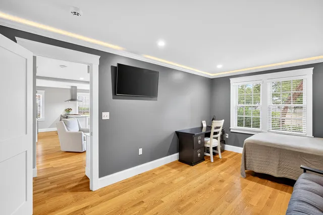 a bathroom with a sink vanity mirror and toilet