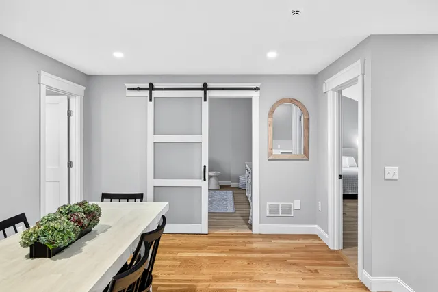 a bedroom with a bed and a mirror