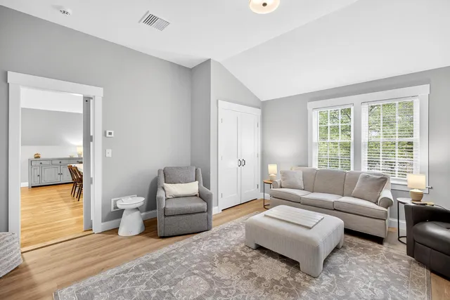 a picture of a room with a white wall and a large window