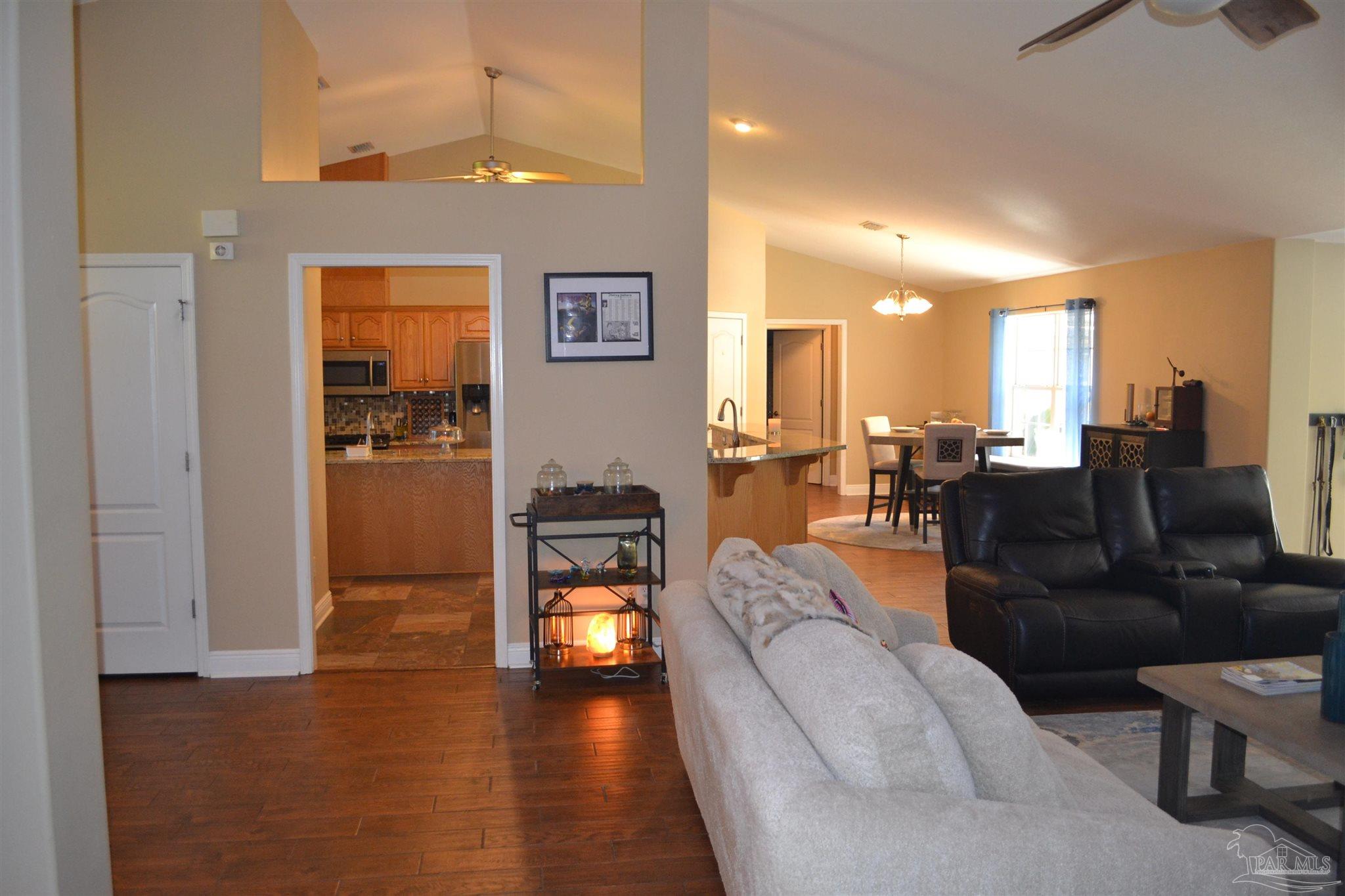 3055 Wallace Lake Road Pace, FL 32571 - Photo 15 of 33 a living room with furniture and a wooden floor