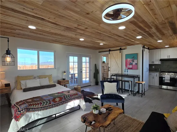 a living room with a couch and a wooden floor