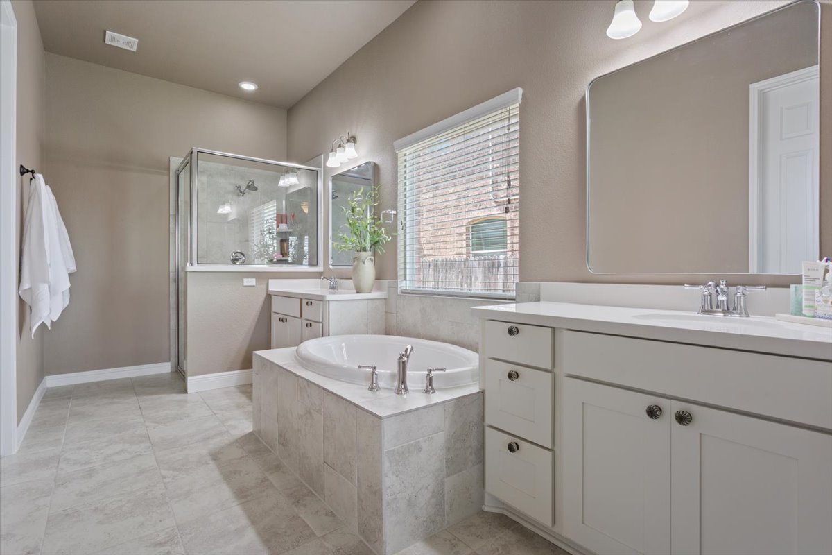 424 Millard Street Georgetown, TX 78628 - Photo 20 of 37 Indulge in a tranquil retreat featuring a spacious soaking tub and an elegant walk-in shower.