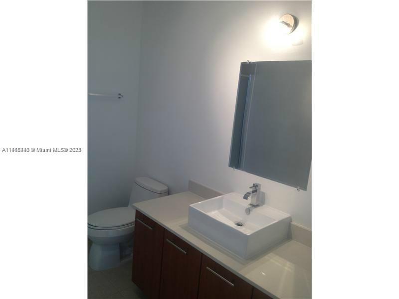 3301 Northeast 1st Avenue, Unit H2408 Miami, FL 33137 - Photo 7 of 10 a bathroom with a sink toilet and mirror