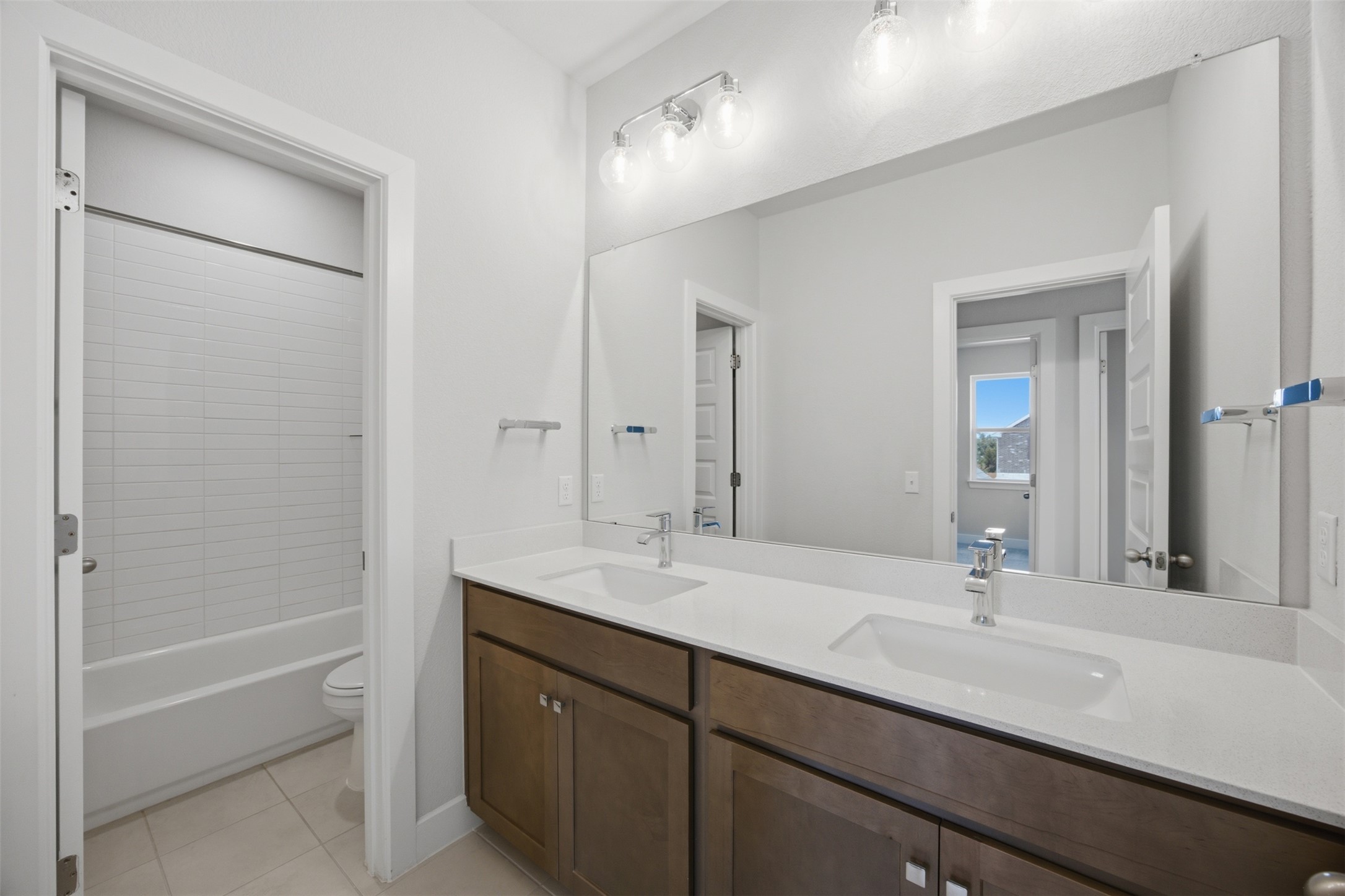 2101 Little Snake Way Georgetown, TX 78633 - Photo 28 of 37 Double vanities with sleek countertops and abundant lighting create a functional and aesthetically pleasing space.