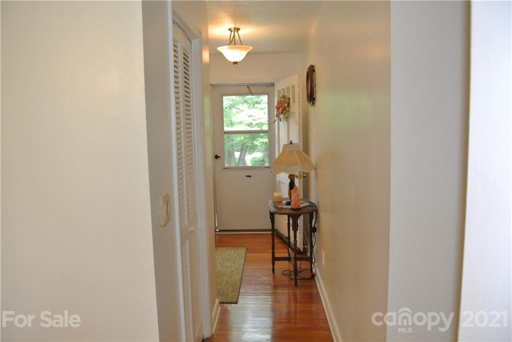 137 Cedar Lane Rutherfordton, NC 28139 - Photo 2 of 26 a view of a hallway with wooden floor and a dining room