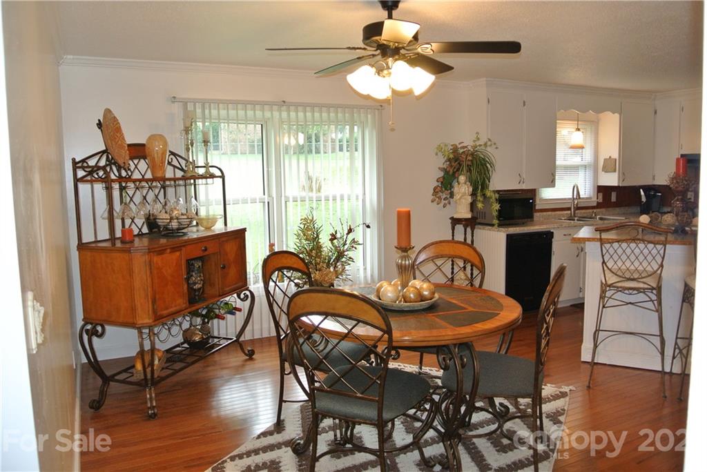 137 Cedar Lane Rutherfordton, NC 28139 - Photo 11 of 26 a dining room with furniture a chandelier and wooden floor