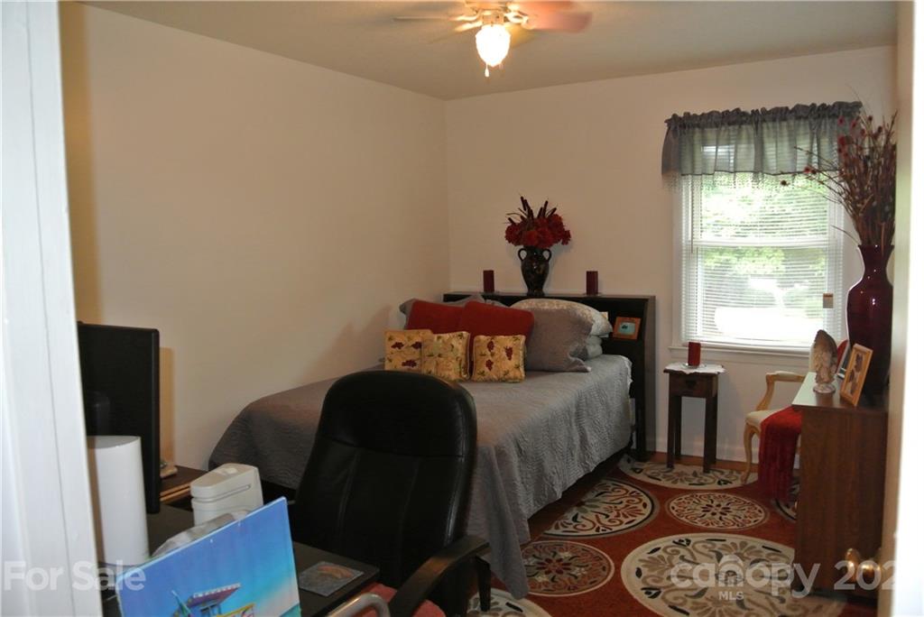 137 Cedar Lane Rutherfordton, NC 28139 - Photo 17 of 26 a bedroom with a bed and a chandelier