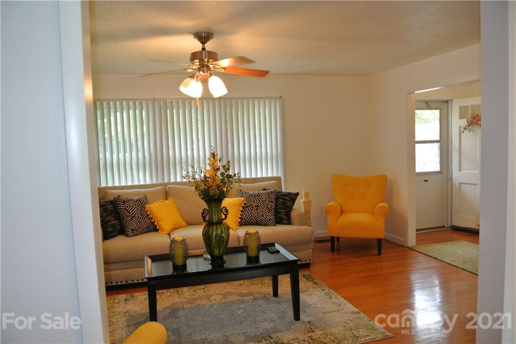 137 Cedar Lane Rutherfordton, NC 28139 - Photo 5 of 26 a living room with furniture and a chandelier