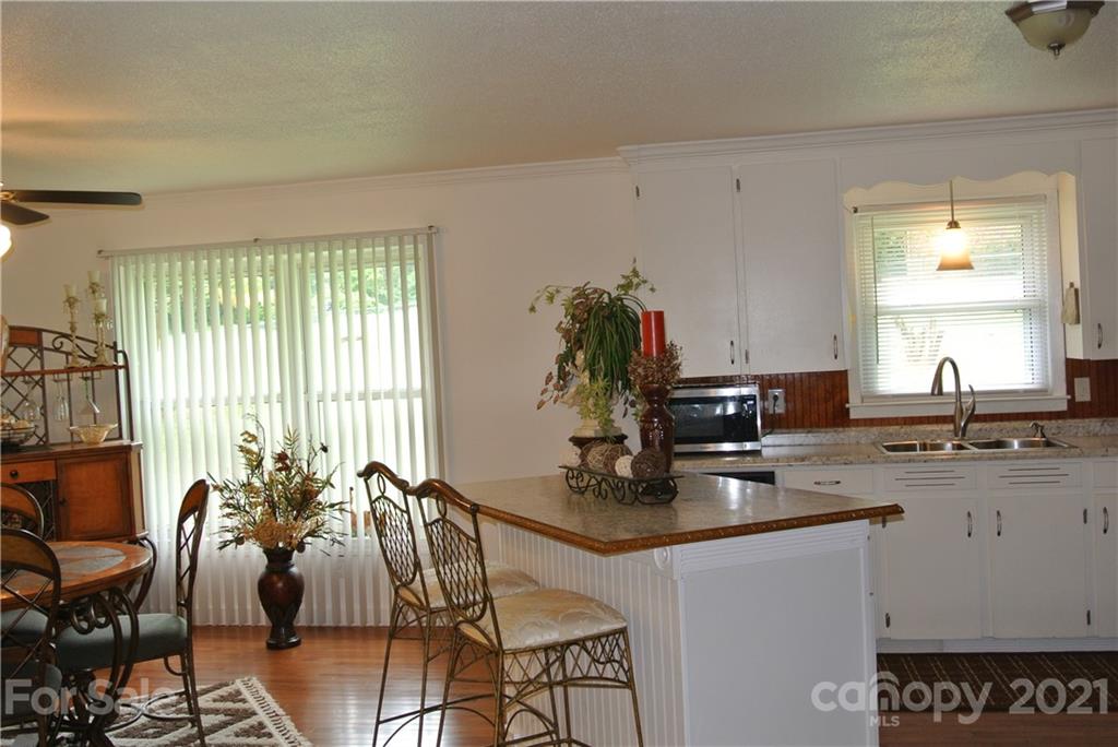 137 Cedar Lane Rutherfordton, NC 28139 - Photo 7 of 26 a dining room with furniture a window and wooden floor