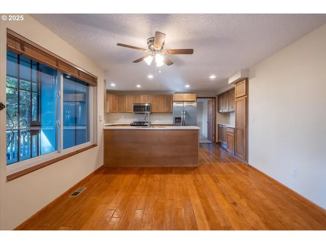 a kitchen with stainless steel appliances kitchen island a refrigerator and a sink