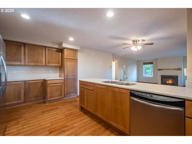 a kitchen with stainless steel appliances granite countertop a sink and cabinets