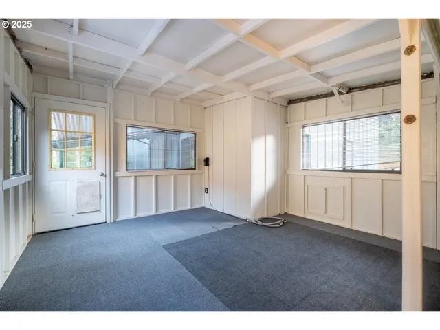 view of empty room with wooden floor and cabinet