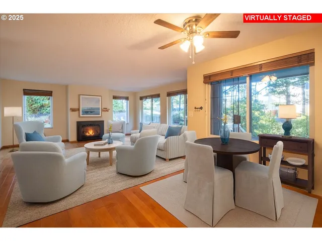 a living room with fireplace furniture and a large window