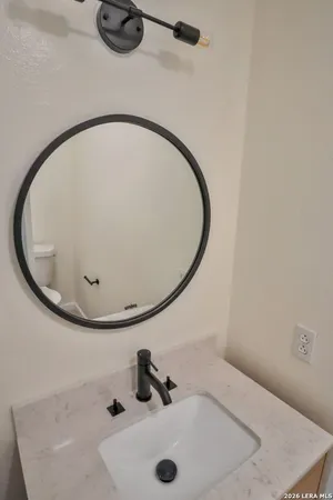 a bathroom with a sink and mirror