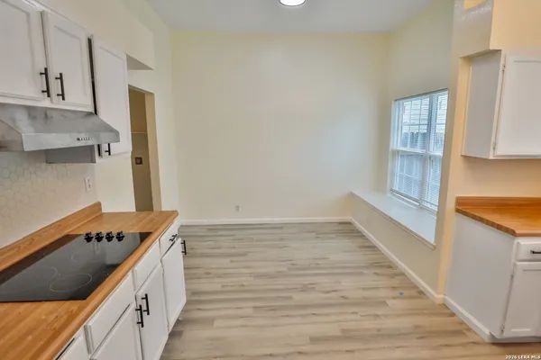 a kitchen with granite countertop a stove and a sink