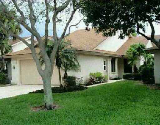 123 Dunes Edge Road Jupiter, FL 33477 - Photo 1 of 1 a front view of a house with a garden