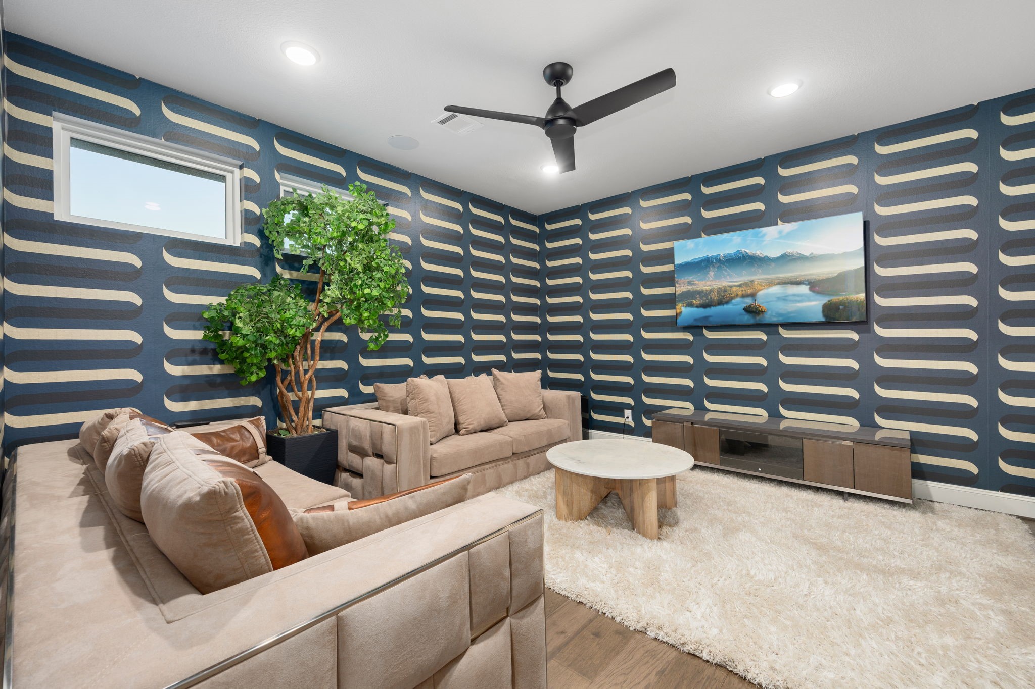 29419 Cir S Rnch Trail Fulshear, TX 77406 - Photo 24 of 45 Located on the upper level, this custom gameroom features designer wallpaper, engineered wood flooring, a central multi-blade ceiling fan, and high windows for natural light.