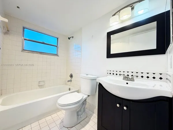 a bathroom with a sink a toilet and a bathtub