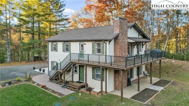 a view of a house with a yard and furniture