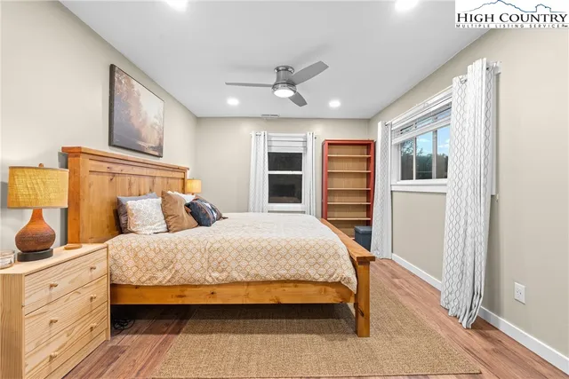 a bedroom with furniture and a wooden floor