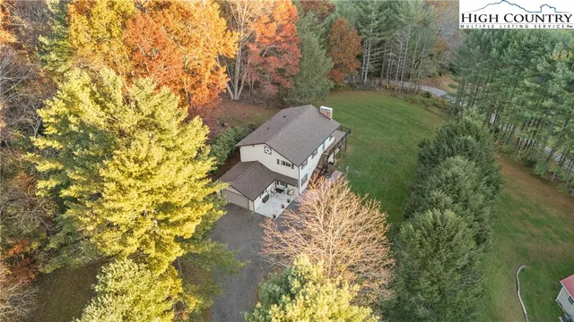 a view of a house with a small yard and wooden fence