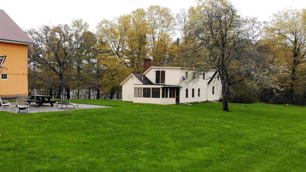 55 Rufus Putnam Road North Brookfield, MA 01535 - Photo 41 of 41 a house that is sitting in the grass with large trees and plants