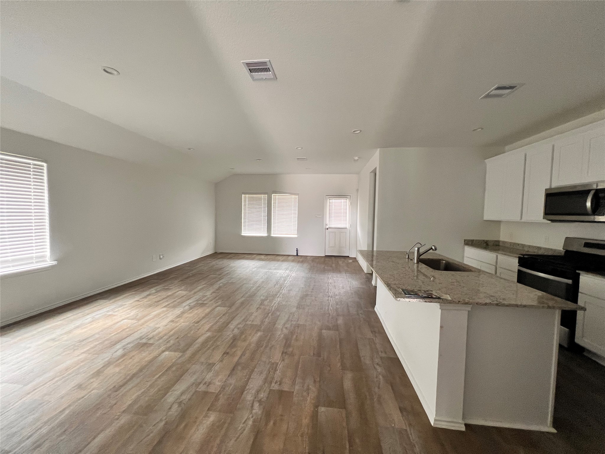 3826 Lanercost Lane Fulshear, TX 77441 - Photo 6 of 29 a kitchen with granite countertop a sink stove and cabinets