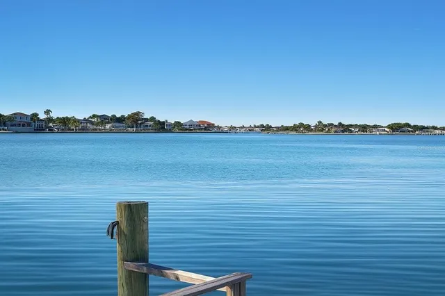 a view of a lake with houses in the background