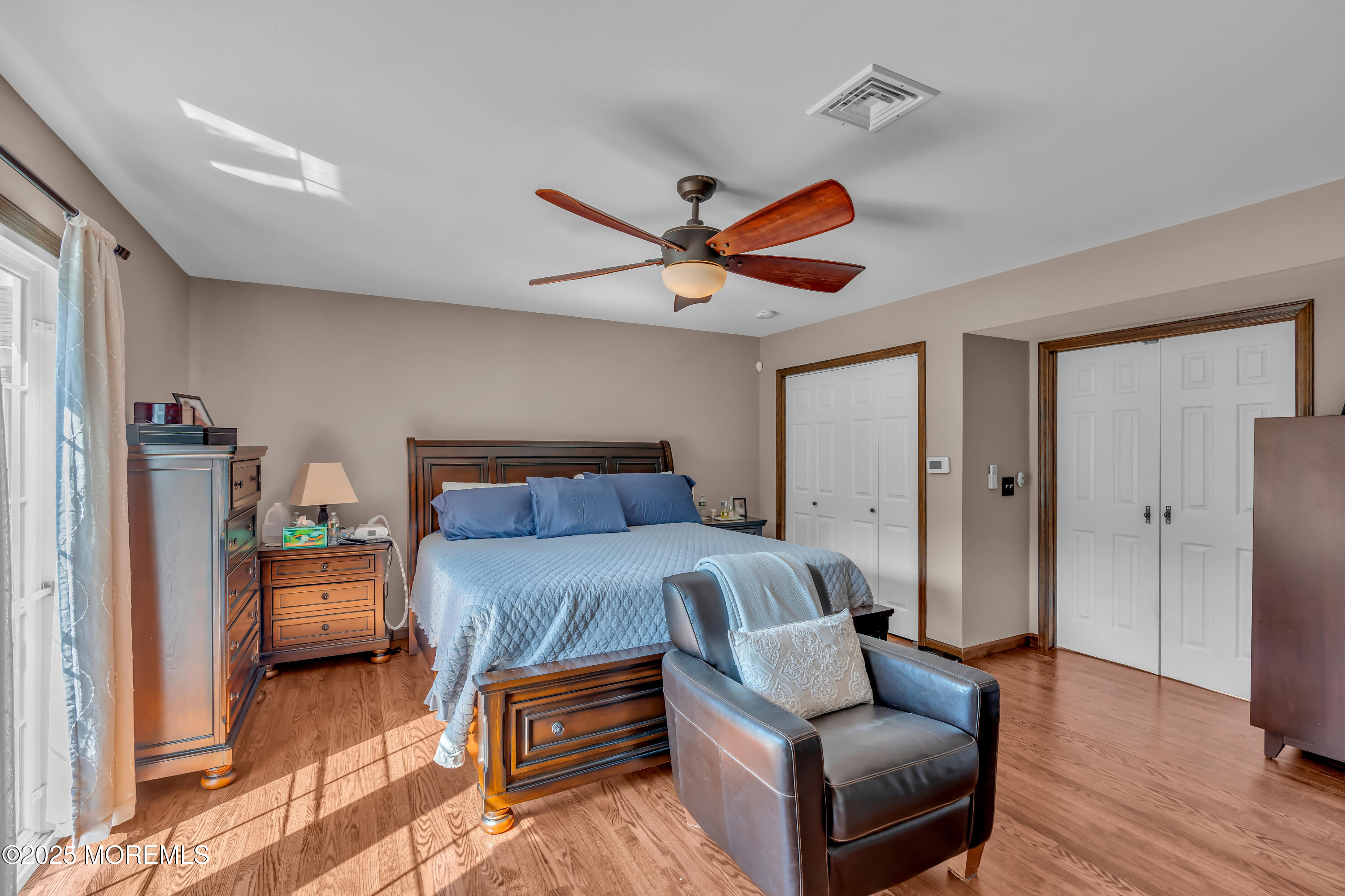1417 Silverton Road Toms River, NJ 08755 - Photo 17 of 41 a bedroom with a bed and a chandelier