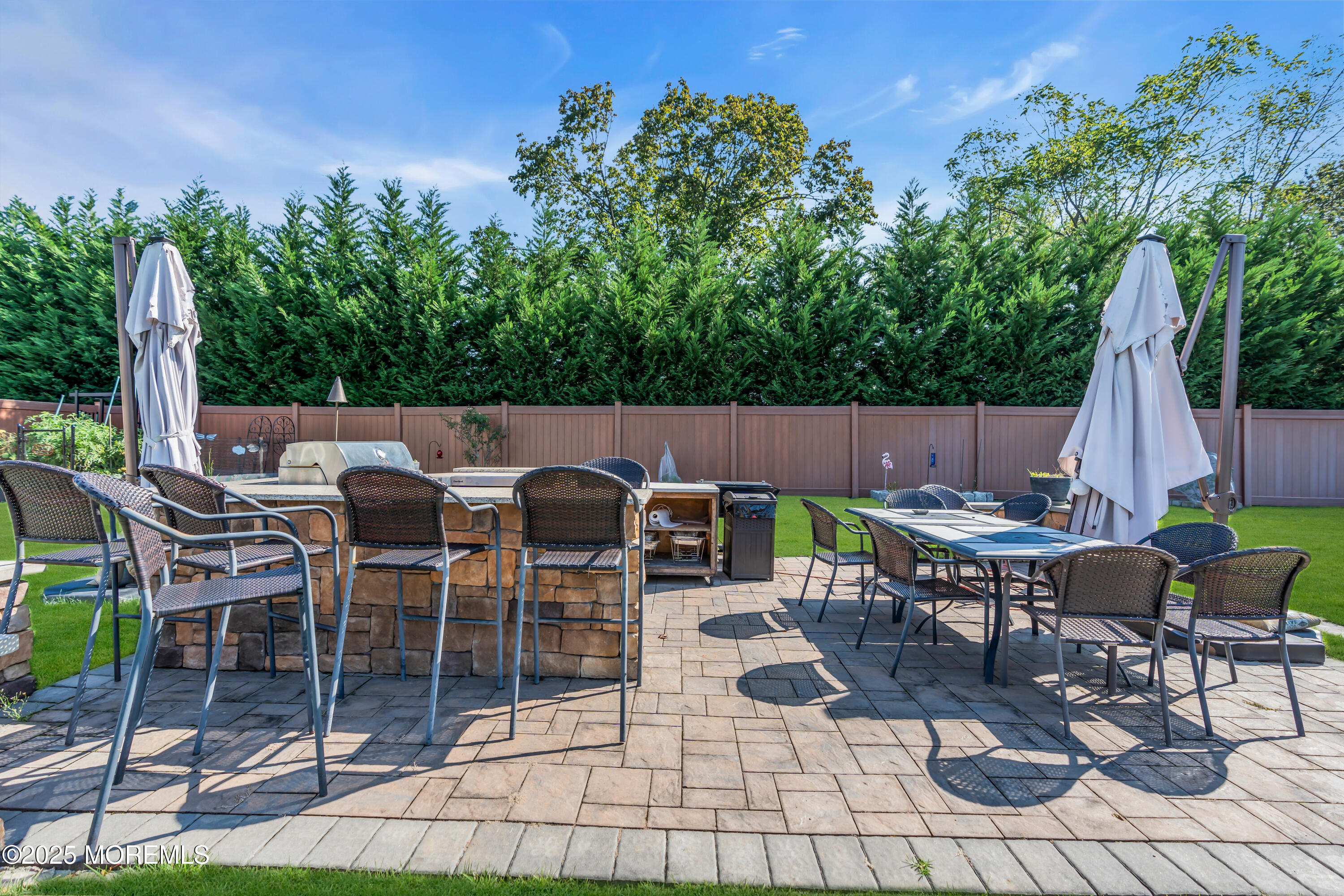 1417 Silverton Road Toms River, NJ 08755 - Photo 33 of 41 a view of a patio with a dining table and chairs with a fire pit