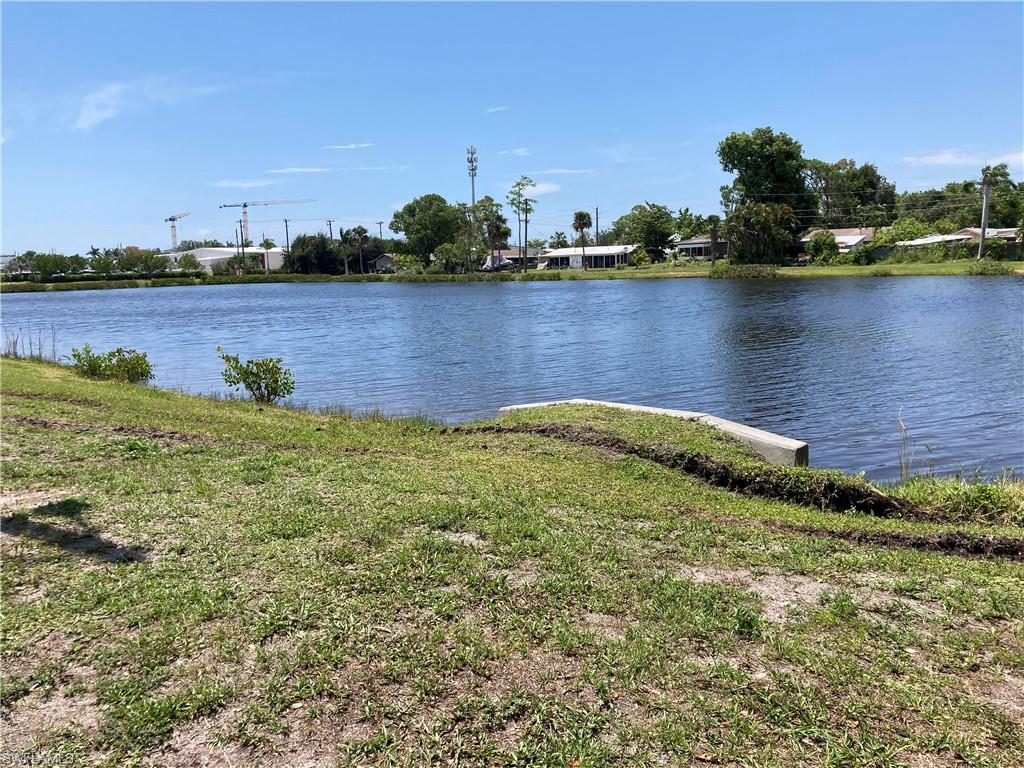 125 Lee Street Naples, FL 34112 - Photo 4 of 10 a view of a lake with houses in the back