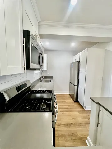 a kitchen with a refrigerator and a sink