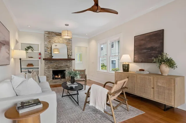 a living room with furniture and a fireplace
