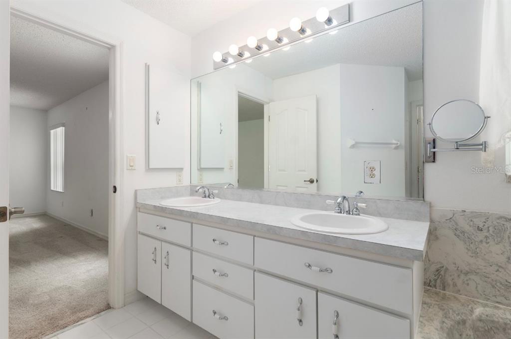 5393 Southwest 109th Place Road Ocala, FL 34476 - Photo 24 of 54 a bathroom with a double vanity sink mirror and next to a window